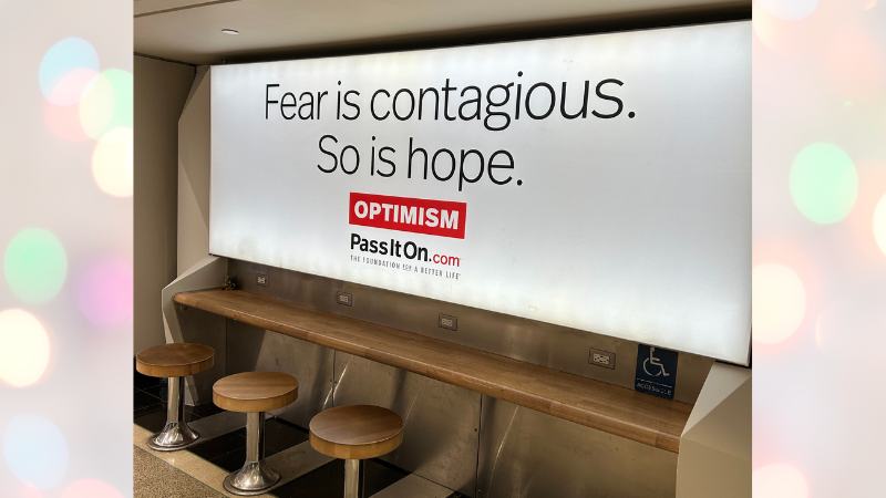 sign photographed in airport: Fear is contagous. So is hope. (Optimism: PassItOn.com)